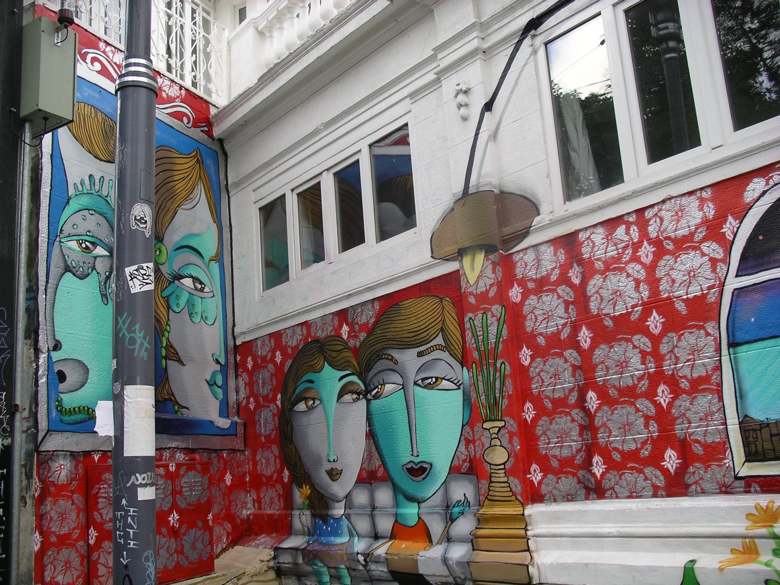 Mural of two women sitting on doorstep chatting