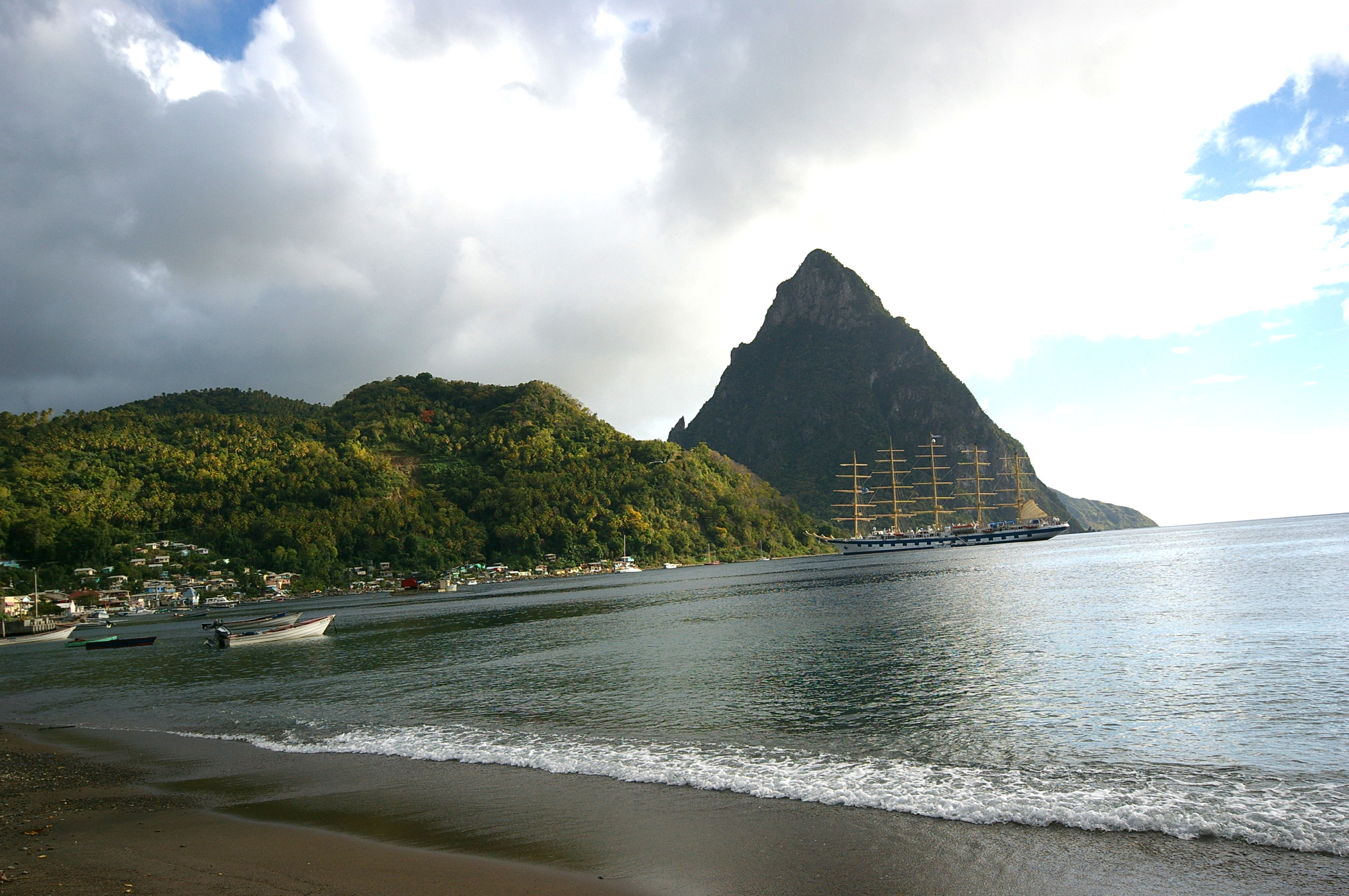 Petit Piton and the hills on the southern side of the bay from Soufriere beach,  It shows the harbour ans some of the town.