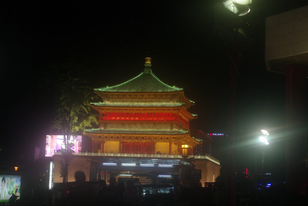 View of the brightly lit pagoda-shaped Xi'an Bell Tower set against the dark night sky